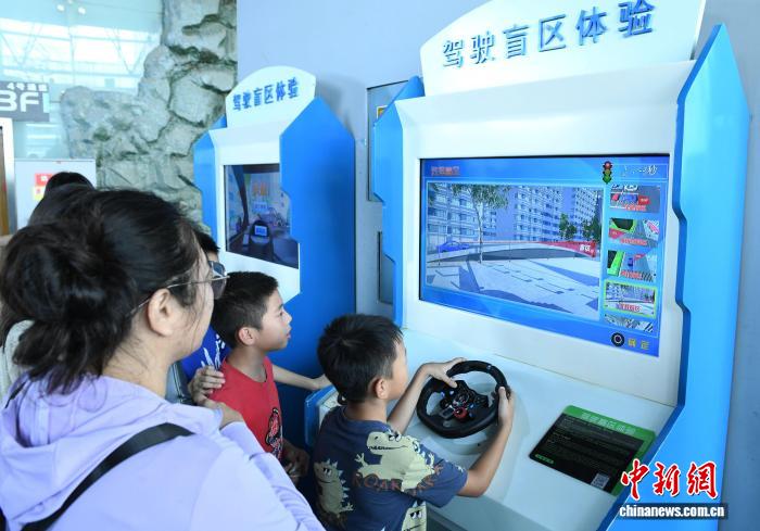 8月21日，正值暑假，重庆科技馆变身儿童乐园，吸引不少市民带着小孩前来参观、游玩，探索科学奥秘。图为小朋友进行驾驶盲区体验。中新社记者 周毅 摄