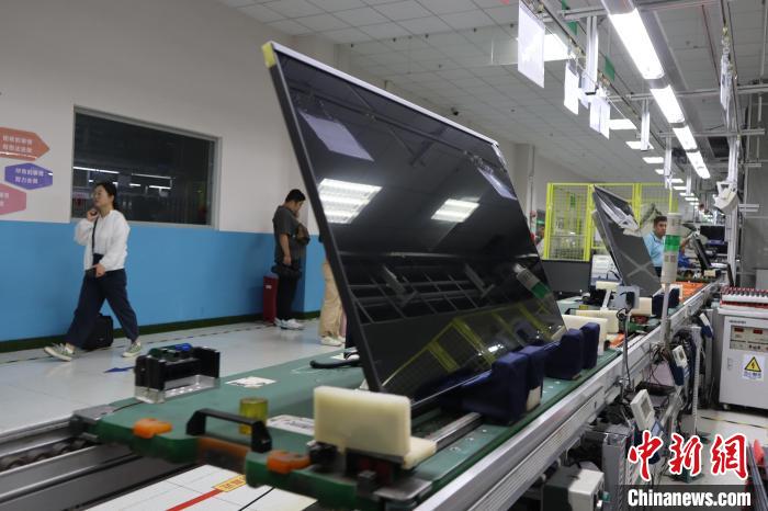 7月7日，中新社记者走进咸阳高新区探寻陕西电子显示产业的发展密码。咸阳G8.5+基板玻璃生产线项目现场，洁净的车间内玻璃液经溢流槽垂落成 0.4 毫米薄片。冠捷显示科技(咸阳)有限公司生产车间则依托自动锁附、智能搬运等自动化设备，每8秒就有一台液晶电视产出。咸阳高新区采取引进龙头企业、完善产业链条和强化科技创新等举措，全力打造千亿级电子显示产业集群。图为冠捷显示科技(咸阳)有限公司的生产现场。中新社记者 李一璠 摄