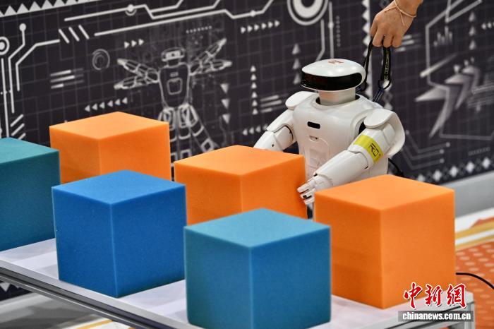 8月24日，第二十七届中国机器人及人工智能大赛人形机器人专项赛全国决赛在安徽省合肥市开赛，该赛事也是中国首个全尺寸人形机器人赛事。比赛吸引了中国近400所高校的6000余名学生参与。赛题紧密围绕工业、家庭服务等真实场景需求，推动人形机器人在多场景中的技术验证与应用突破。图为Roban机器人进行智能搬运的比赛瞬间。中新社记者 韩苏原 摄